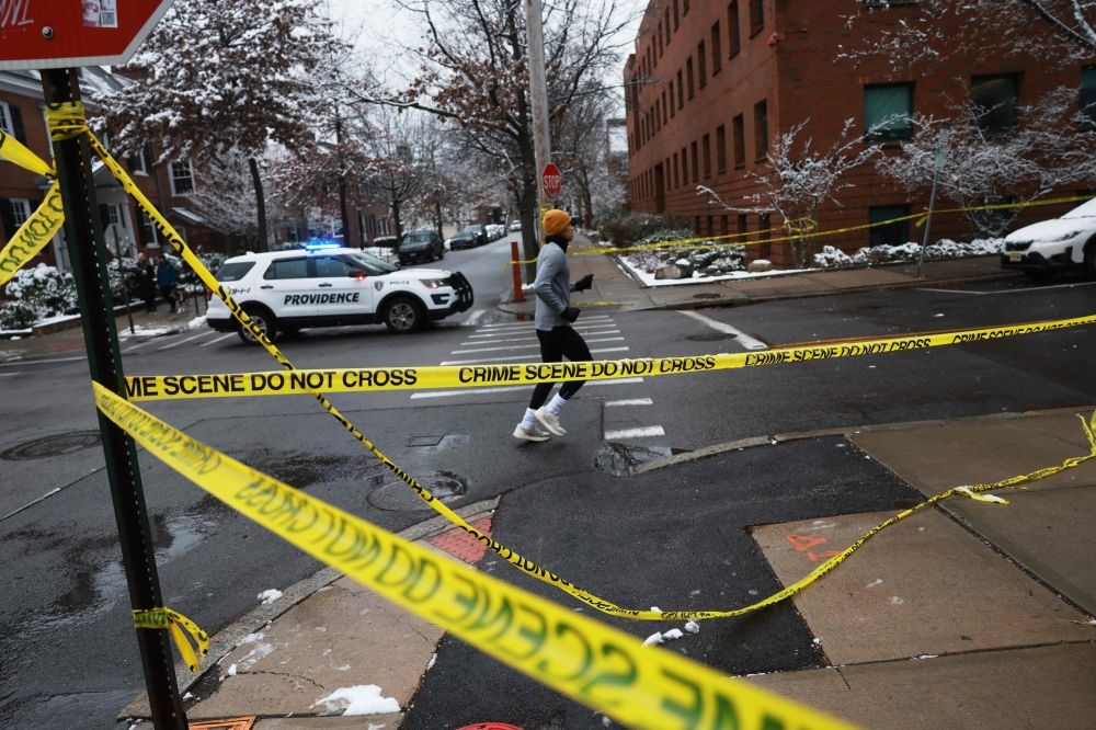 A person jogs by police tape near the campus at Brown University a day after a mass shooting that left at least two people dead and nine others injured on December 14, 2025 in Providence, Rhode Island. — Getty Images pic via AFP A person jogs by police tape near the campus at Brown University a day after a mass shooting that left at least two people dead and nine others injured on December 14, 2025 in Providence, Rhode Island. — Getty Images pic via AFP
