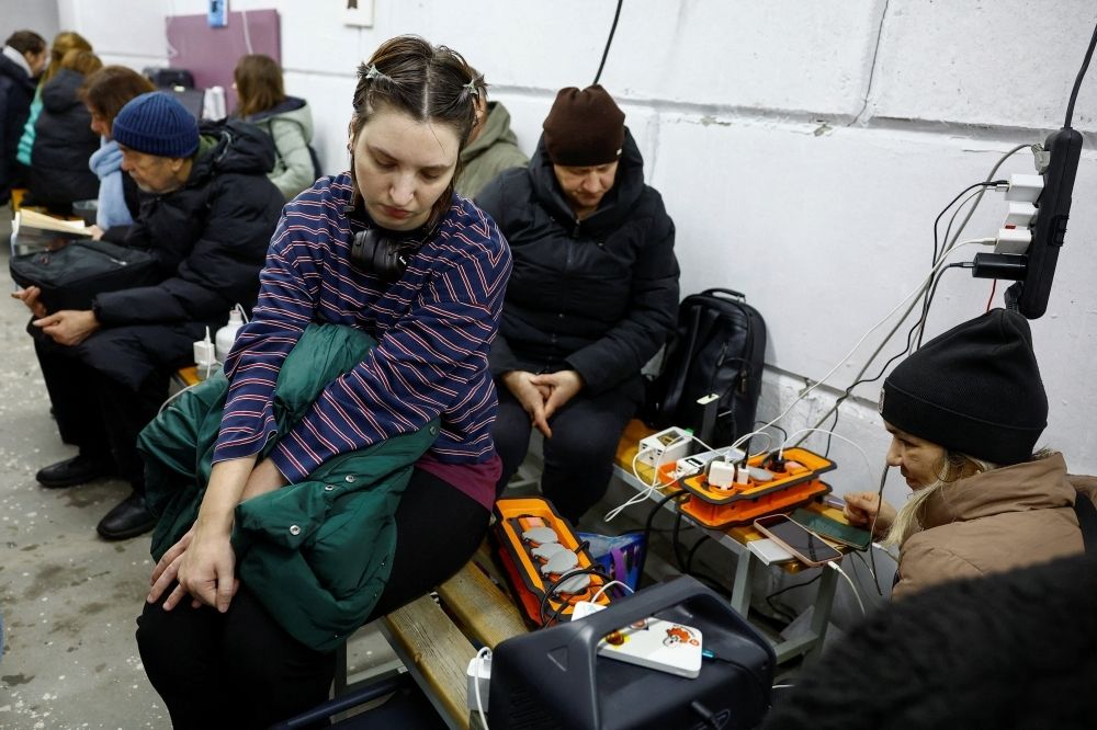 Ukrainians withstand days-long power cuts in crowded ‘resilience’ shelters Residents charge their devices inside a support point, situated in a bomb shelter, during a long power blackout after critical civil infrastructure was hit by a Russian missile and drone strikes, in the town of Vyshhorod in Kyiv region, Ukraine, December 29, 2025. — Reuters pic
