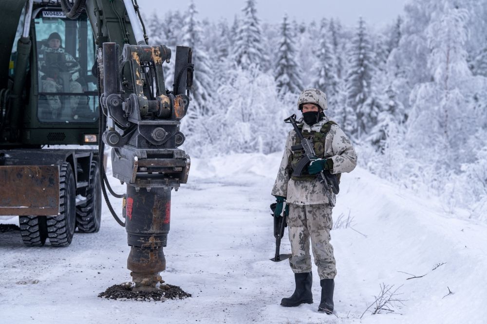 An excavator is seen next to Finnish military personnel in winter camouflage during a land mine installation demonstration at the Kainuu Brigade in Kajaani, Finland, on February 3, 2026. — AFP pic An excavator is seen next to Finnish military personnel in winter camouflage during a land mine installation demonstration at the Kainuu Brigade in Kajaani, Finland, on February 3, 2026. — AFP pic