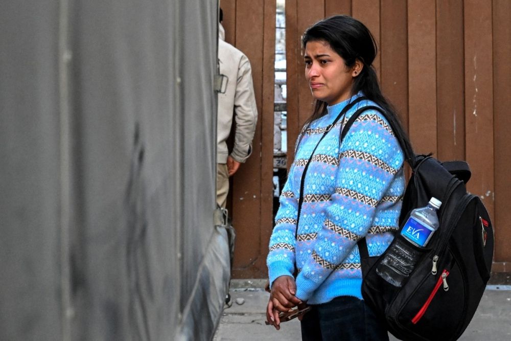 This photograph taken on January 21, 2026 shows a relative of migrant worker Rudra Bahadur Kami mourning as his coffin is loaded onto a truck upon its arrival at Tribhuvan International Airport in Kathmandu. — AFP pic This photograph taken on January 21, 2026 shows a relative of migrant worker Rudra Bahadur Kami mourning as his coffin is loaded onto a truck upon its arrival at Tribhuvan International Airport in Kathmandu. — AFP pic