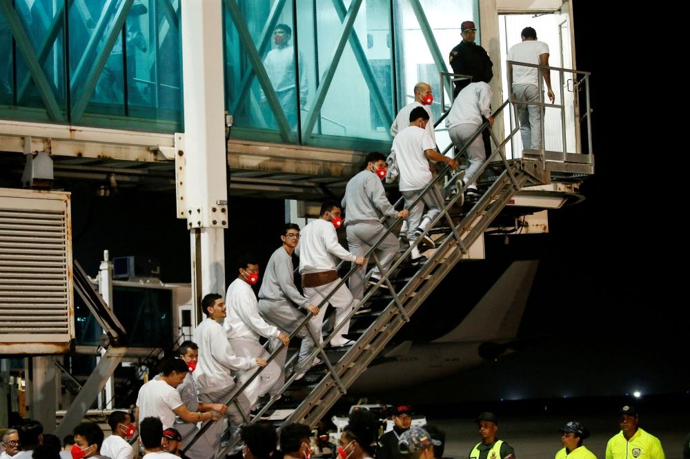 Venezuelan migrants flown from Guantanamo Bay via Honduras, walk up a ladder after arriving on a deportation flight at Simon Bolivar International Airport in Maiquetia, La Guaira State, Venezuela, February 20, 2025. — Reuters pic Venezuelan migrants flown from Guantanamo Bay via Honduras, walk up a ladder after arriving on a deportation flight at Simon Bolivar International Airport in Maiquetia, La Guaira State, Venezuela, February 20, 2025. — Reuters pic