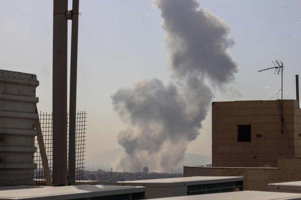 A plume of smoke rises following a reported explosion in Tehran on February 28, 2026. — AFP pic A plume of smoke rises following a reported explosion in Tehran on February 28, 2026. — AFP pic