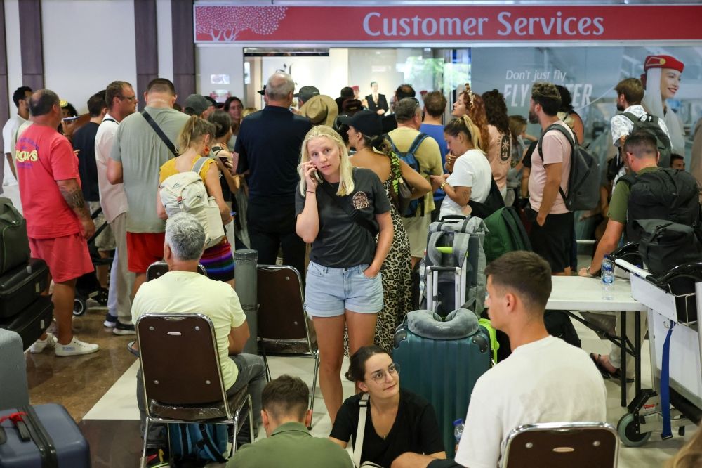 Stranded passengers wait near Emirates Airways customer service office at I Gusti Ngurah Rai International Airport after flights to Doha, Dubai, and Abu Dhabi were cancelled following strikes on Iran launched by the United States and Israel, in Kuta, Bali March 1, 2026. — Reuters pic Stranded passengers wait near Emirates Airways customer service office at I Gusti Ngurah Rai International Airport after flights to Doha, Dubai, and Abu Dhabi were cancelled following strikes on Iran launched by the United States and Israel, in Kuta, Bali March 1, 2026. — Reuters pic