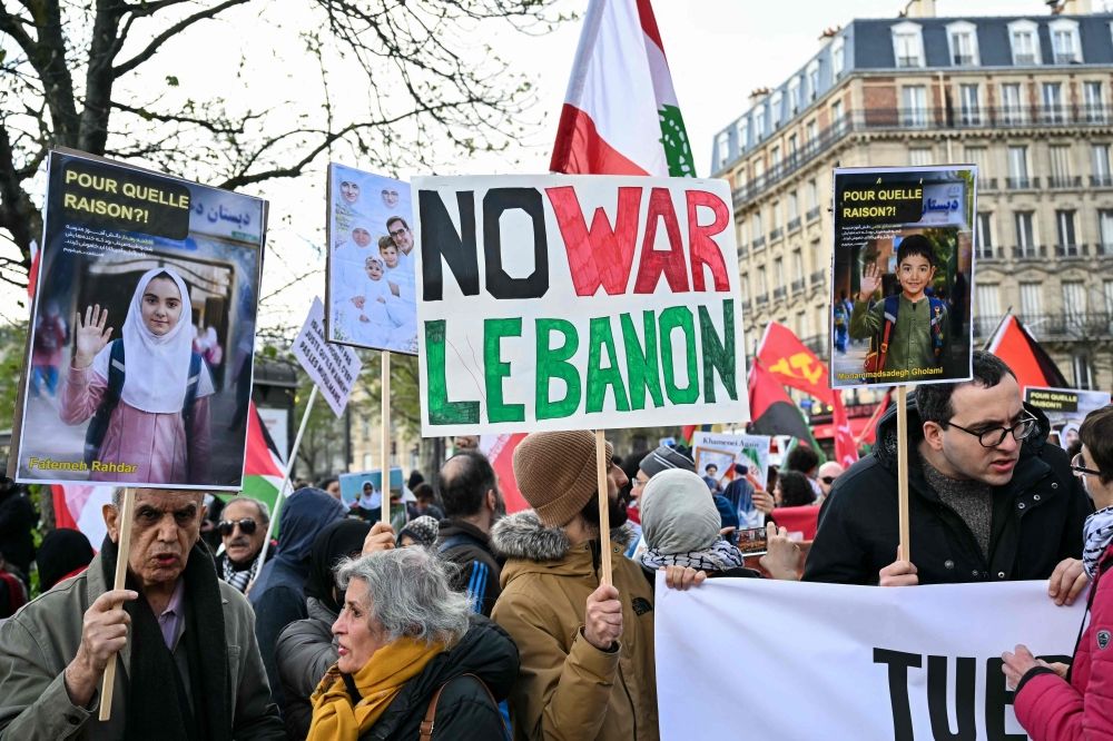 A protester holds a banner reading ‘No war Lebanon’ during a march against Middle East's war, triggered by the joint US-Israeli strikes alongside a rally against racism, fascism and state violence, in Paris on March 14, 2026. — AFP pic A protester holds a banner reading ‘No war Lebanon’ during a march against Middle East's war, triggered by the joint US-Israeli strikes alongside a rally against racism, fascism and state violence, in Paris on March 14, 2026. — AFP pic
