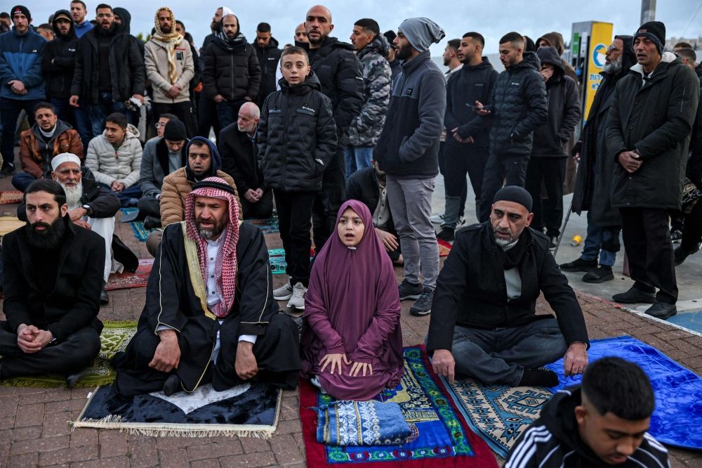Muslim worshippers gather outside the Jerusalem old city walls on March 20, 2026 to attend attend the early morning prayers for Eid al-Fitr, marking the end of the holy month of Ramadan. — AFP pic Muslim worshippers gather outside the Jerusalem old city walls on March 20, 2026 to attend attend the early morning prayers for Eid al-Fitr, marking the end of the holy month of Ramadan. — AFP pic