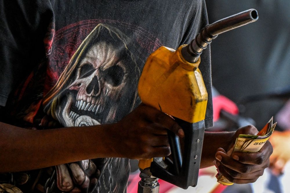 An employee collects cash after filling petrol in a motorbike at a filling station in Wellawatte on the outskirts of Colombo on March 16, 2026. Fuel in Sri Lanka has gone up by a third and supply is rationed, and in turn increasing electricity costs by up to 40 per cent since the US-Israel war against Iran and the retaliation strikes began on February 28, 2026, disrupting global energy supplies. — AFP pic