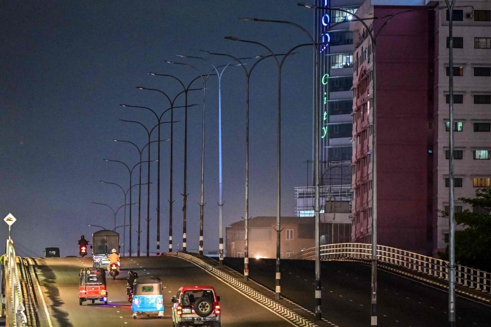 Vehicles move past switched-off street lights along a flyover in Colombo on April 2, 2026 as authorities order measures to save electricity amid an energy shortage across the country. — AFP pic