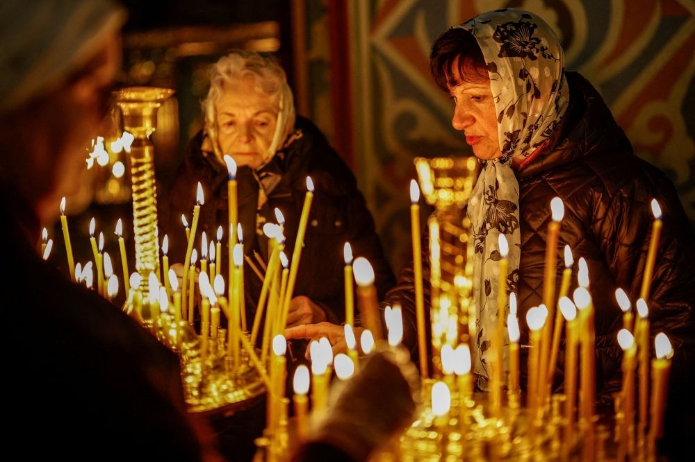 Russia–Ukraine Easter ceasefire begins despite deadly strikes hours before it took effect Believers light candles during a service ahead of Orthodox Easter, during a 32‑hour ceasefire declared by Russia, inside the St. Michael's Cathedral, amid Russia’s attack on Ukraine, in Kyiv April 11, 2026. — Reuters pic
