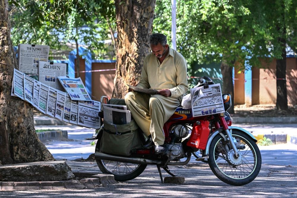 A vendor reads a newspaper displayed on a roadside after the US-Iran peace talks in Islamabad on April 12, 2026. — AFP pic A vendor reads a newspaper displayed on a roadside after the US-Iran peace talks in Islamabad on April 12, 2026. — AFP pic