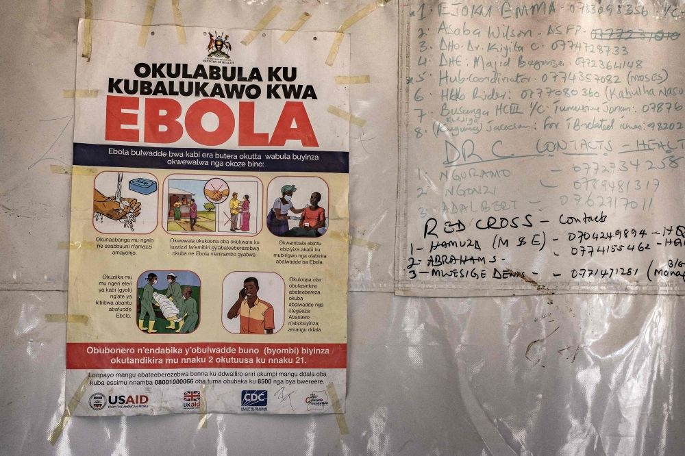 WHO chief raises alarm over ‘scale and speed’ of Ebola outbreak A poster displaying Ebola emergency contact numbers is pinned to a tent at the Busunga border crossing between Uganda and the Democratic Republic of Congo in Bundibugyo on May 18, 2026. — AFP pic