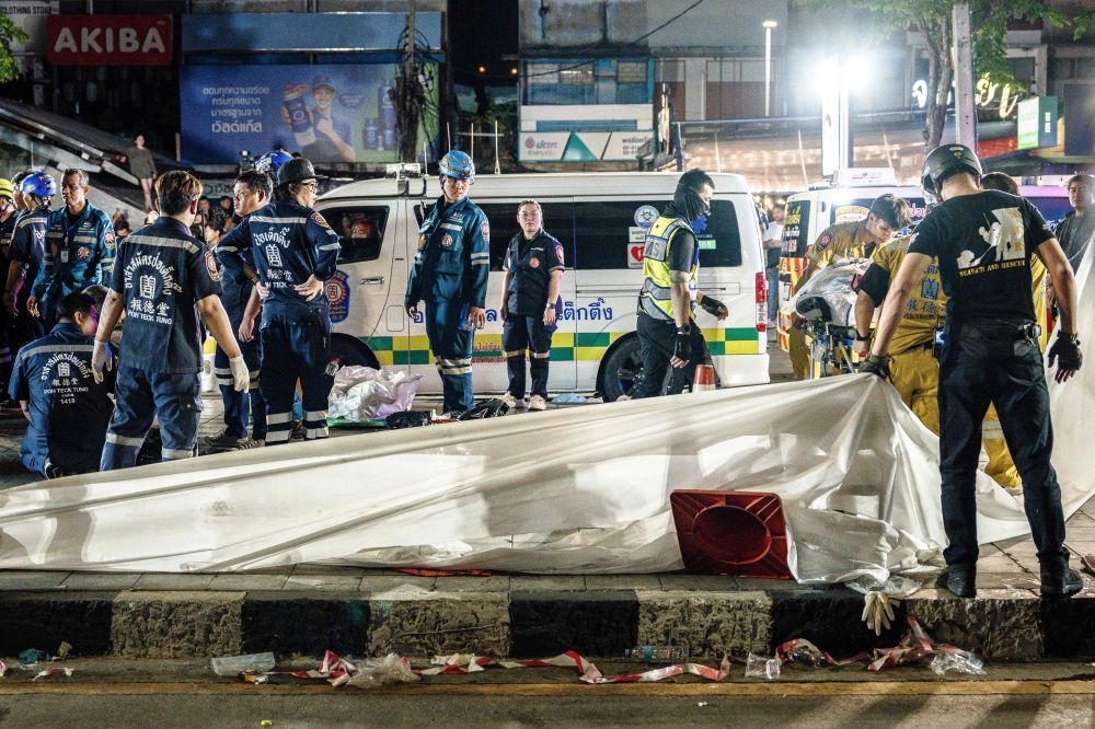 Emergency workers prepare to place the bodies of victims into ambulances after a fire at the Rong Beer Na Lat Phrao bar in Bangkok on July 13, 2026. — AFP pic Emergency workers prepare to place the bodies of victims into ambulances after a fire at the Rong Beer Na Lat Phrao bar in Bangkok on July 13, 2026. — AFP pic