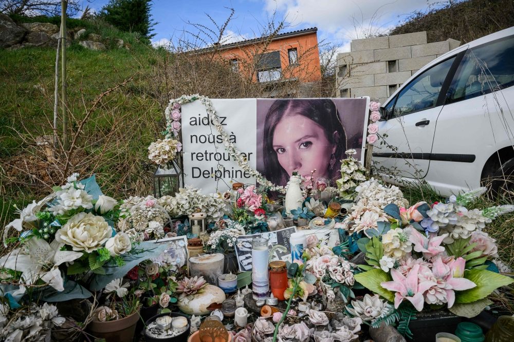 Confession cracks one of France’s most haunting missing person cases after husband jailed for 30 years Flowers, candles and a portrait of Delphine Jubillar, a 33-year-old French nurse who went missing in 2020, are placed outside the family home in Cagnac-les-Mines. Her husband later confessed to her killing and led investigators to her remains. — AFP pic