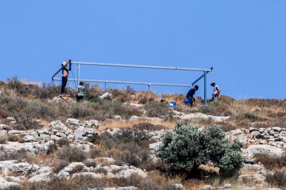 Israeli settlers build a new outpost at the Palestinian village of Azmut in the occupied West Bank on July 17, 2026. — AFP Israeli settlers build a new outpost at the Palestinian village of Azmut in the occupied West Bank on July 17, 2026. — AFP