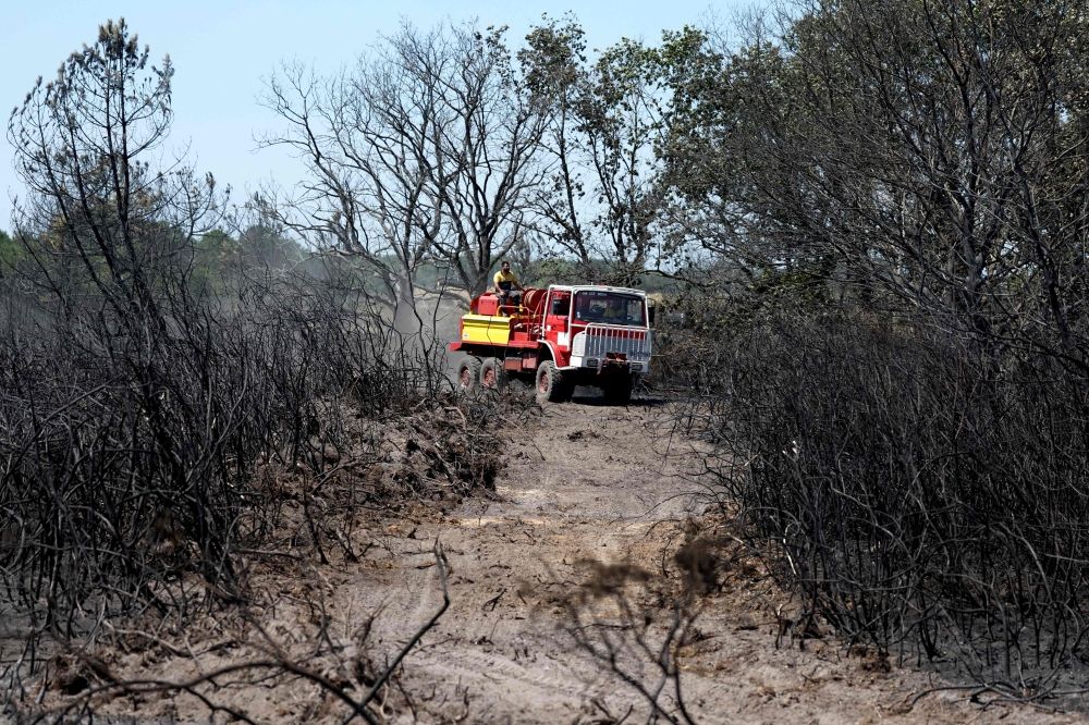 France, Spain evacuate 160,000 as wildfires tear through Bordeaux and Madrid Locals drive an old fire truck at the site where a wildfire broke out on July 21 and where two firefighters lost their lives while fighting a fire in Merignac, close to the Bordeaux-Mérignac airport, south-western France, on July 22, 2026. — AFP pic
