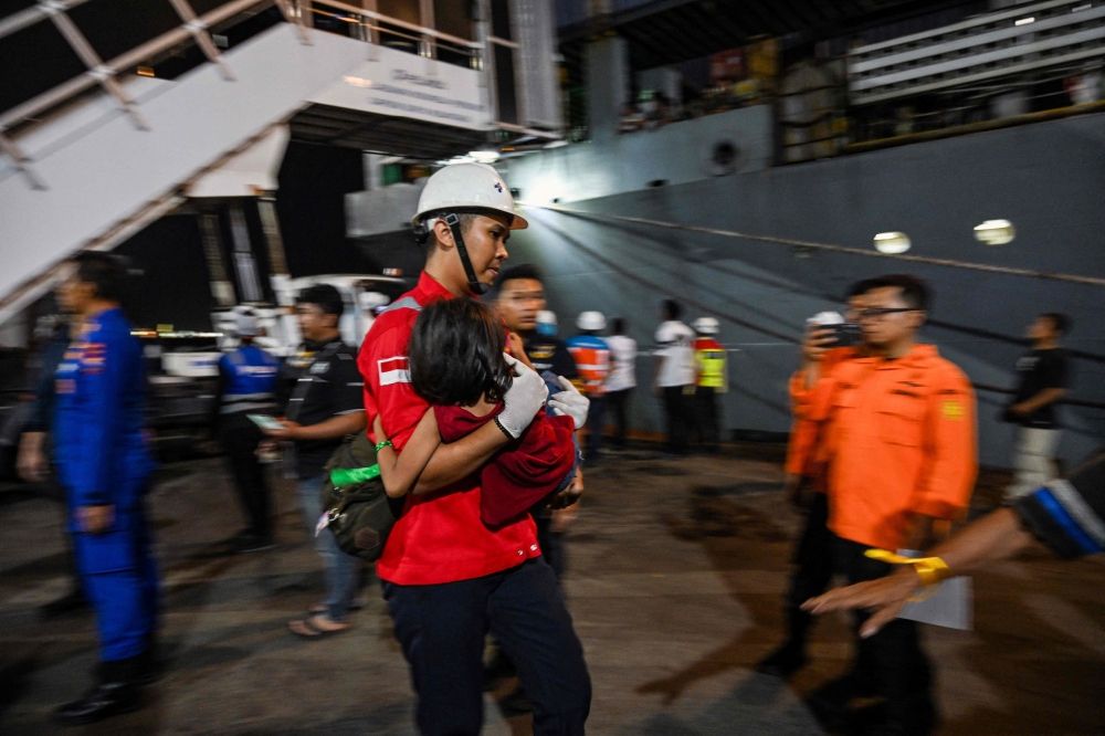 Indonesia ferry fire toll confirmed at five after all survivors accounted for A rescue worker carries a child who survived a fire on the Mutiara Sentosa 2 ferry in the waters off Madura island, East Java, on August 2, 2026, at Tanjung Perak port in Surabaya early August 3, 2026. — AFP pic
