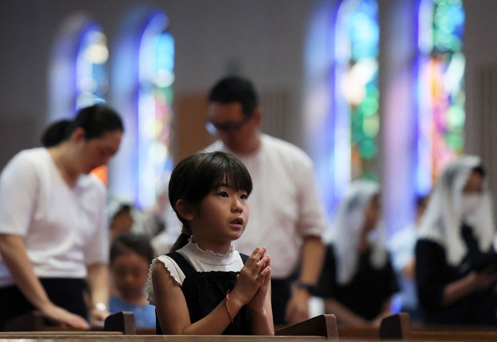 A girl prays during mass at Urakami Cathedral in Nagasaki on August 9, 2026, marking the 81st anniversary of the atomic bombing. — JIJI Press/Japan OUT/ AFP pic A girl prays during mass at Urakami Cathedral in Nagasaki on August 9, 2026, marking the 81st anniversary of the atomic bombing. — JIJI Press/Japan OUT/ AFP pic