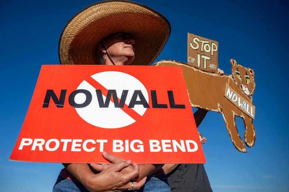 A woman holds a sign protesting plans by US President Donald Trump’s administration to build a section of border wall at Big Bend National Park in Study Butte, Texas, on August 15, 2026. The administration has since paused the US$1.7 billion project following fierce bipartisan opposition. — AFP pic A woman holds a sign protesting plans by US President Donald Trump’s administration to build a section of border wall at Big Bend National Park in Study Butte, Texas, on August 15, 2026. The administration has since paused the US$1.7 billion project following fierce bipartisan opposition. — AFP pic
