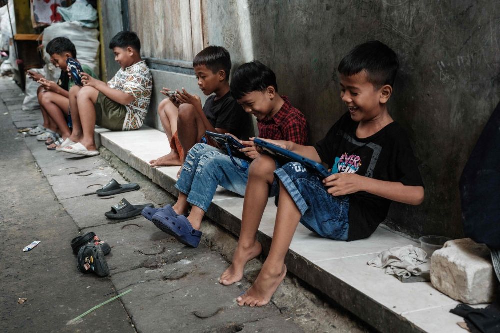More countries move to ban social media for children, with restrictions spreading worldwide Children play online games against each other on smartphones and tablets along an alley in Jakarta in this file photo taken on March 26, 2026. The European Union is to unveil proposals yesterday aimed at curbing addictive features of social media for minors, as a growing number of countries look to restrict children’s access to the platforms. — AFP pic