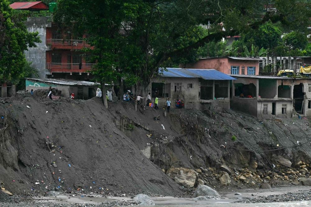 People wait to cross the Trishuli river via a zip line, in the aftermath of August 26 flash flood, at Devighat in Nepal's Nuwakot district on September 24, 2026. — AFP pic People wait to cross the Trishuli river via a zip line, in the aftermath of August 26 flash flood, at Devighat in Nepal's Nuwakot district on September 24, 2026. — AFP pic