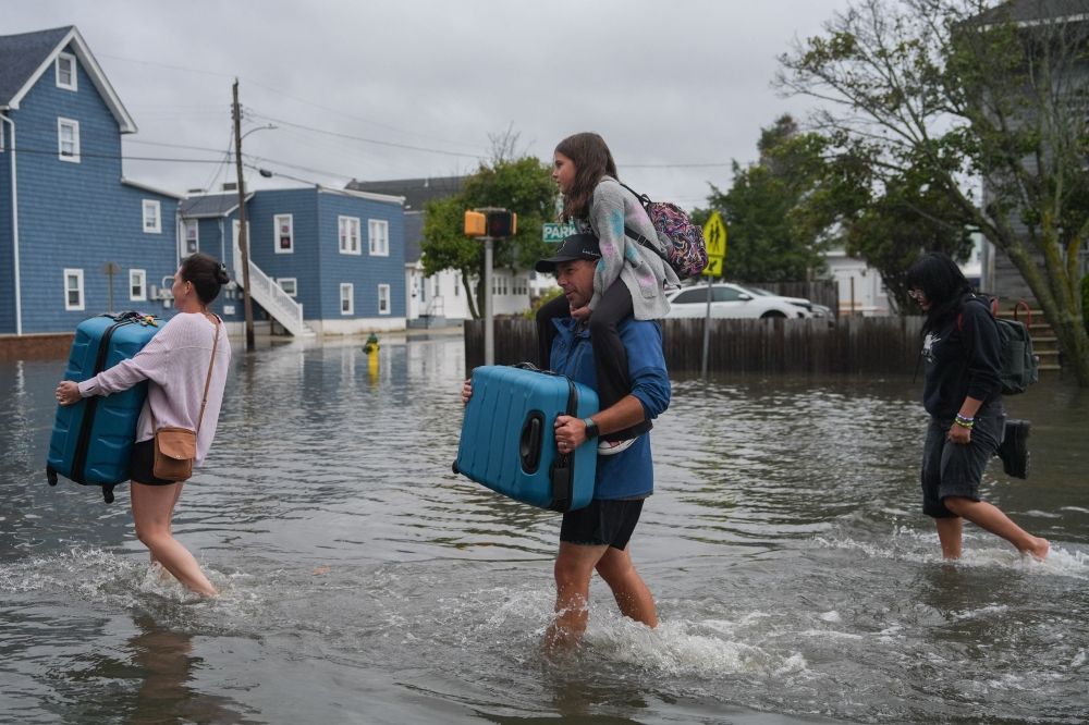 A family carries their belongings through floodwaters during a nor’easter in Point Pleasant, New Jersey, September 26, 2026. — AFP pic A family carries their belongings through floodwaters during a nor’easter in Point Pleasant, New Jersey, September 26, 2026. — AFP pic