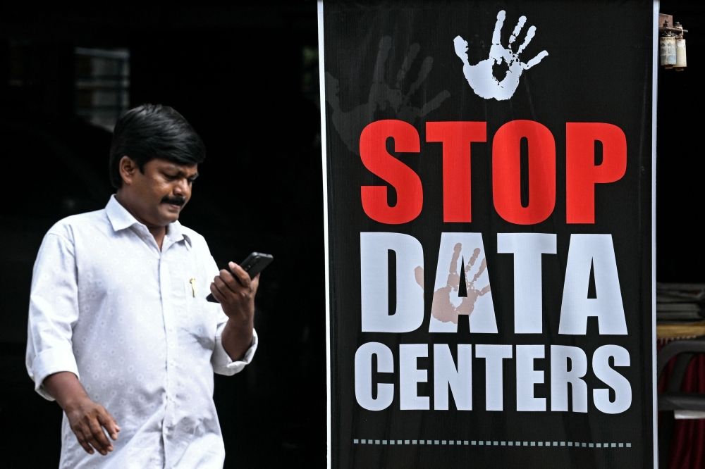 ‘Why here?’ India activists demand moratorium as Google’s AI hub scars land and sparks water fears Handcuffs encircle Google’s logo on one campaign poster, while another warns that people ‘cannot drink data’, as opposition mounts to the tech giant’s planned AI mega‑facility in India. — AFP pic