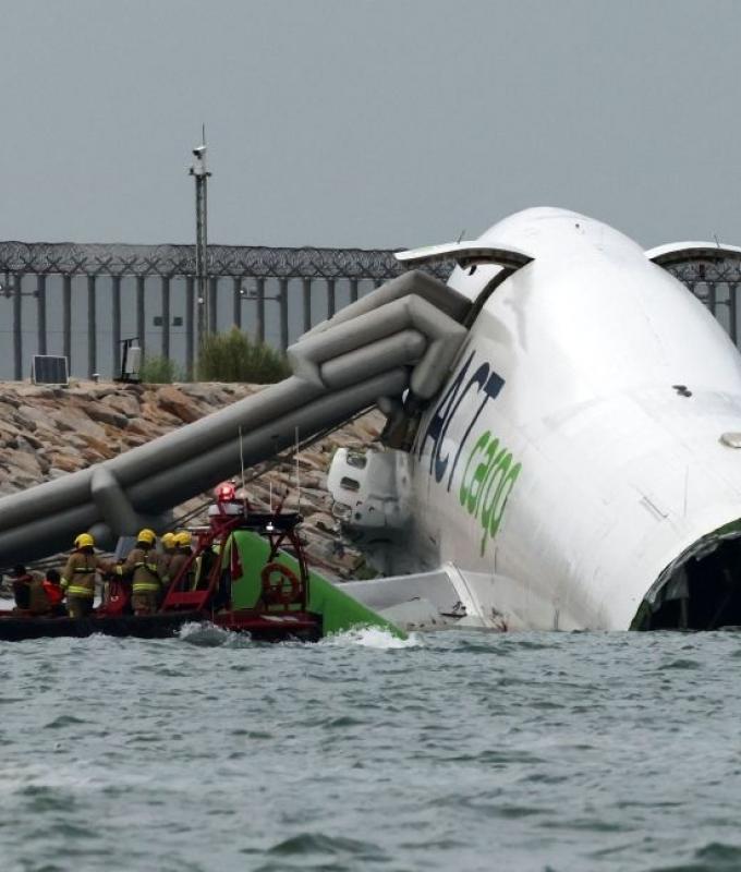 Cargo plane skids off runway into sea at Hong Kong airport, killing two in patrol vehicle, flights unaffected