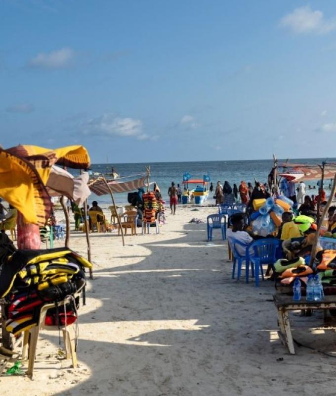 What draws travellers to Mogadishu despite Al-Shabaab threats and Western advisories?