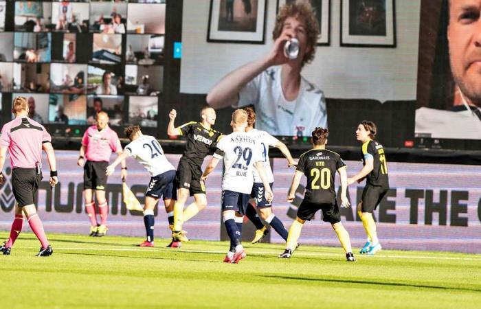 A Zoom wall, cheers piped in and cut-out fans as Danish football returns with 'virtual grandstand' - in pictures