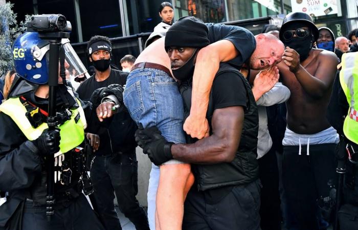 Black British protester reflects on viral photo of him helping white man