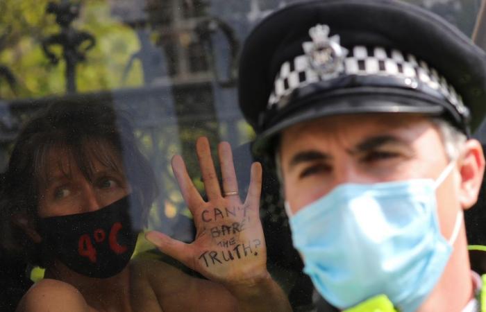 Bare-chested women lock themselves to UK parliament in climate protest