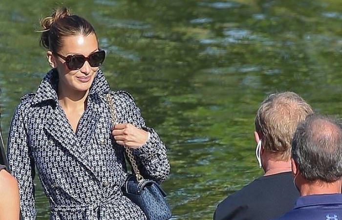 Bella Hadid shows sculpted legs in a chic 1950s wrap coat...