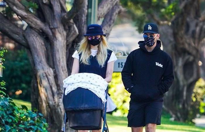 Sophie Turner pushes little daughter Willa into a stroller while out...