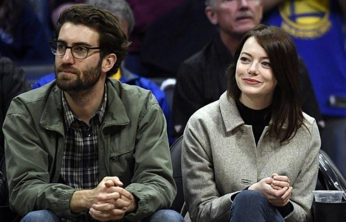 Emma Stone looks cozy in a green cardigan when she goes...