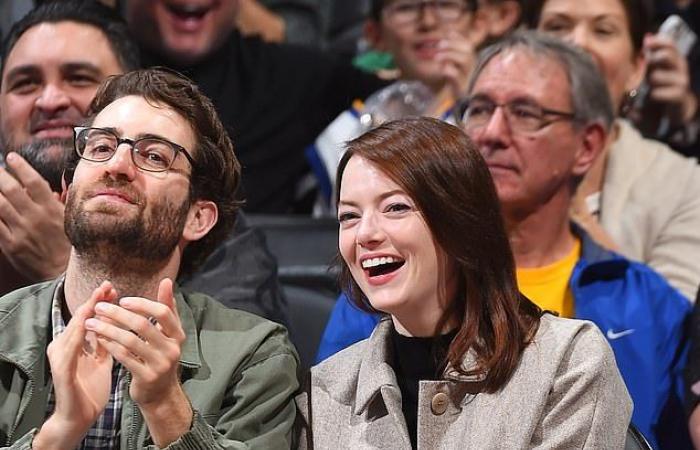 Emma Stone looks cozy in a green cardigan when she goes...