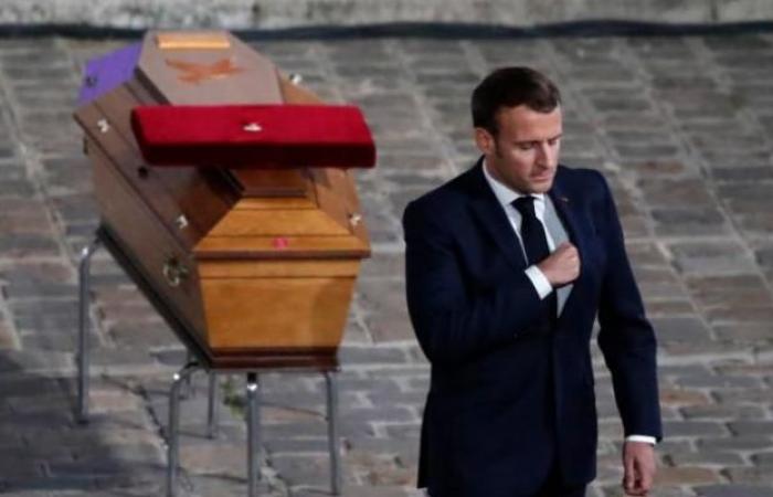 Macron at the memorial service for the slain teacher, tears filled...
