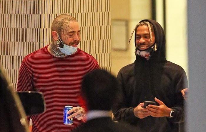 Post Malone shows his freshly shaved head as he greets Ty...