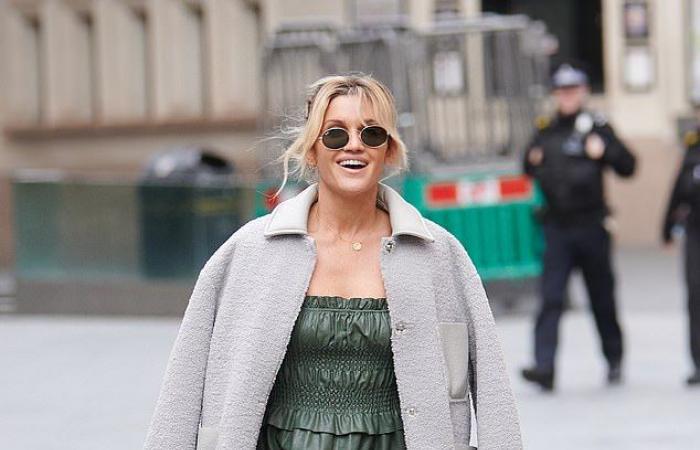 Ashley Roberts wears a leather look dress with oversized sleeves