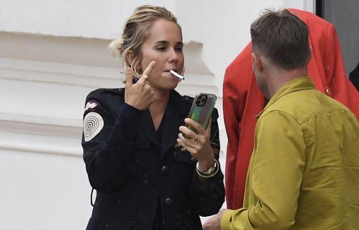 Pip Edwards blows on a cigarette and makes herself comfortable with...