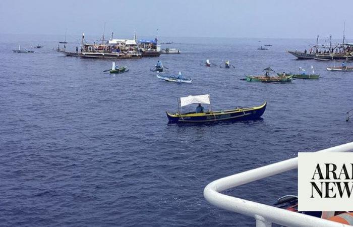 Filipino activists and fishermen sail in 100-boat flotilla to disputed shoal guarded by China