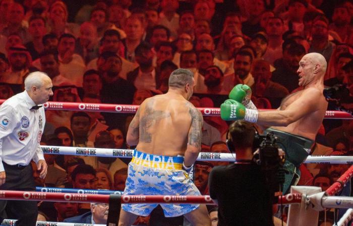 Usyk in tears for late father after historic heavyweight win