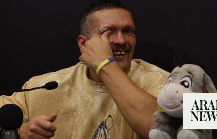 Usyk in tears for late father after historic heavyweight win