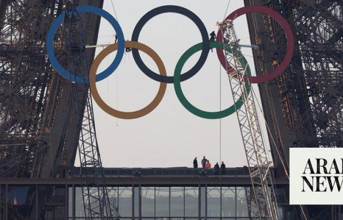 Paris Olympics organizers unveil a display of the five Olympic rings mounted on the Eiffel Tower