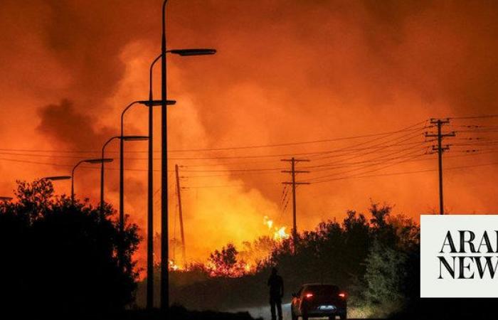 Wildfire rages outside Athens fanned by strong winds