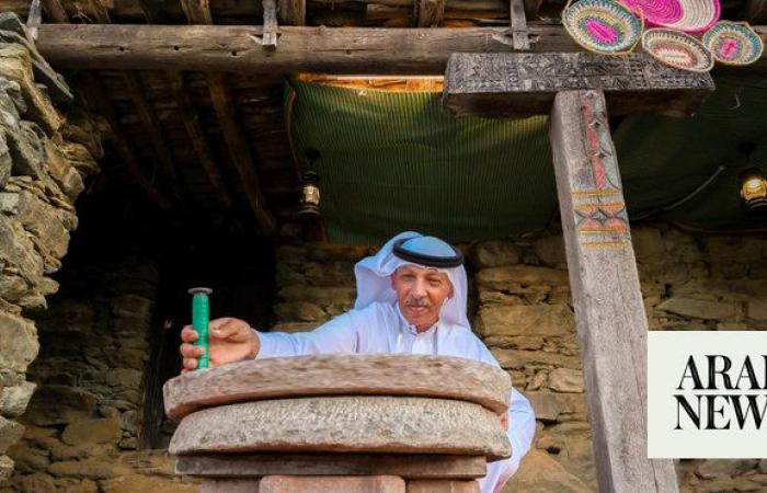Millstone attracts visitors during Dar Festival at Al-Mousa Heritage Village