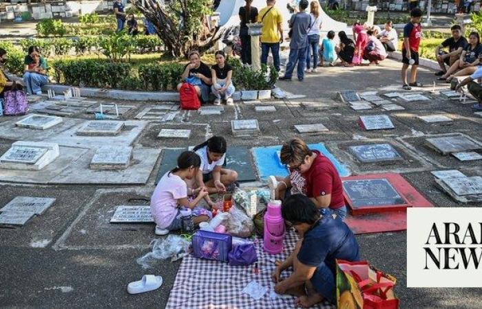 Filipinos honor their dead with flowers, food in All Saints’ Day rites