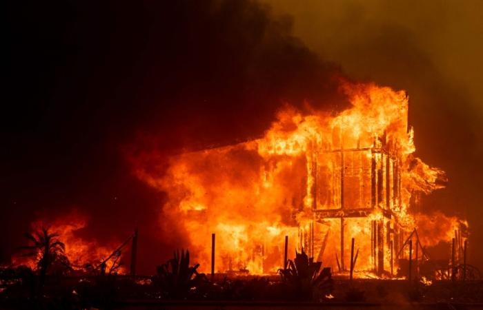 Thousands flee as hurricane-force winds drive ‘dangerously fast’ wildfire through Los Angeles suburbs