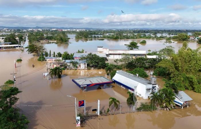 Massive floods engulf northern Philippines after typhoon and dam release, displacing thousands