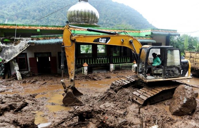 Indonesia turns to heavy machinery in search for landslide victims as deadly floods claim 20 lives