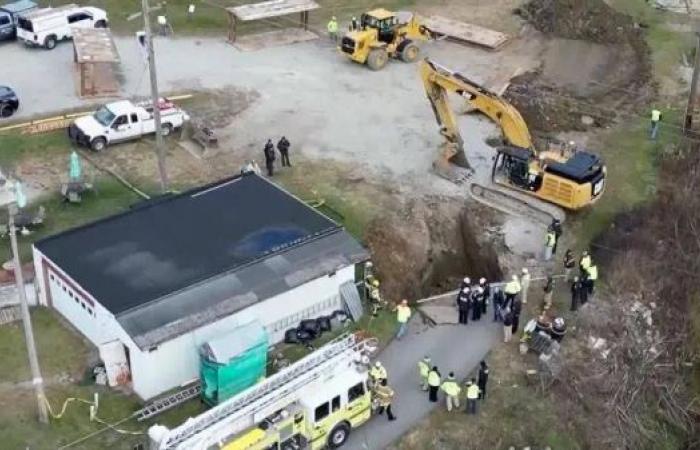 Search under way for woman believed trapped in sinkhole