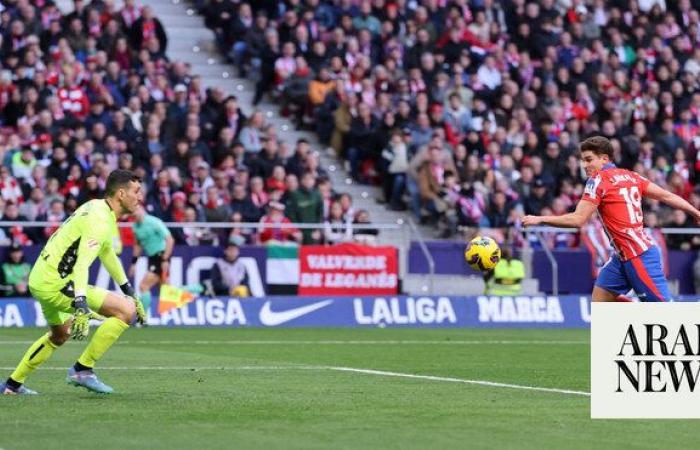 Atletico Madrid wins record 14th game in a row to lead Spanish league at halfway stage